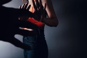 A woman fighting off a man.